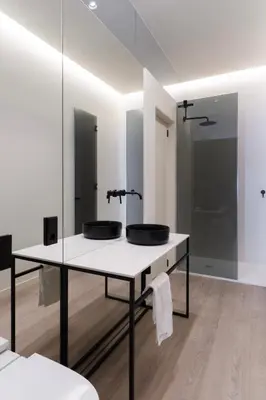 a bathroom with two sinks on a table with mirrors at Cosy Loft's Valencia in Catarroja