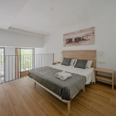 a bedroom with a large bed with two towels on it at NEW DUPLEX, 2 WC, FRENTE CIUDAD DE LAS CIENCIAS Y LAS ARTES in Valencia