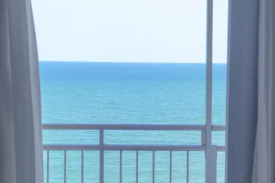 a view of the ocean from a hotel room window at Comfortable and Elegant Seafront Apartment in Faro de Cullera