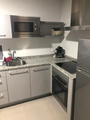 a kitchen with a sink and a stove top oven at playa in Almenara