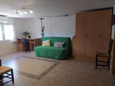 a bedroom with two beds and a dresser and a window at La caseta del llorer in Catadau