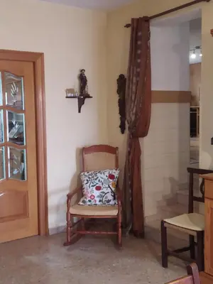a living room with a table and a couch at La caseta del llorer in Catadau