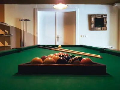 a pool table with balls and bats on it at Casa Cosy in Serra