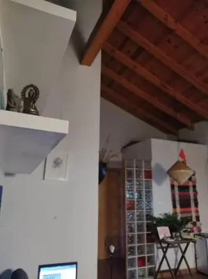 a kitchen with wooden ceilings and a room with a table at Casita Mona y Acogedora in Alaquas