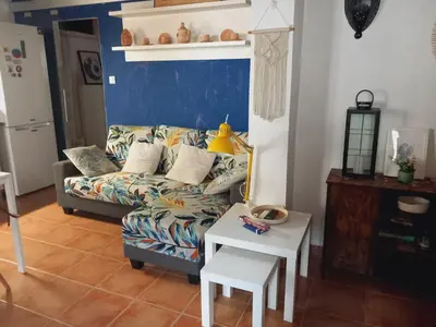 a living room with a couch and a table at Casita Mona y Acogedora in Alaquas