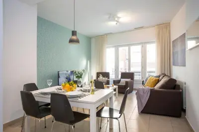 a dining room and living room with a table and chairs at SingularStays Mar44 in Valencia