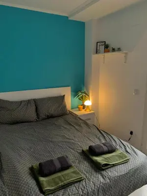 a bedroom with a bed with two pillows on it at Cosy and Modern Puerto de Sagunto Holiday Flat in Puerto de Sagunto