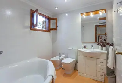 a bathroom with a tub and a toilet and a sink at VILLA LATEL in Serra