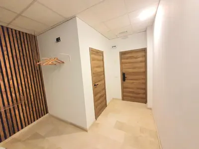 a hallway with two wooden doors in a room at PLAZA HOME ResEst in Valencia