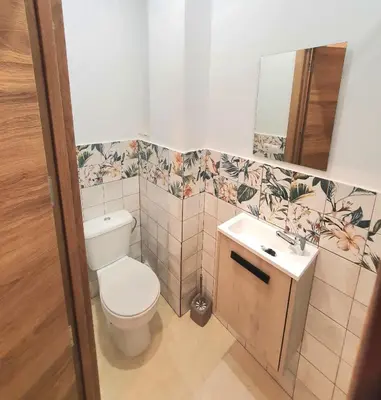 a bathroom with a toilet and a sink and a mirror at PLAZA HOME ResEst in Valencia