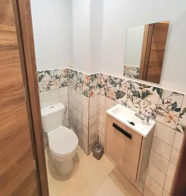 a bathroom with a toilet and a sink and a mirror at PLAZA HOME ResEst in Valencia