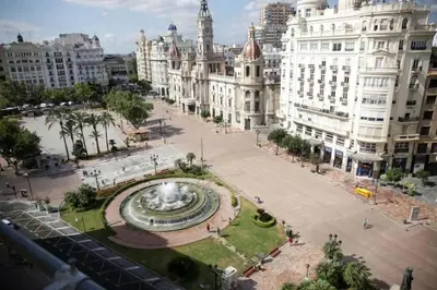 a large fountain in a city with buildings at PLAZA HOME ResEst in Valencia