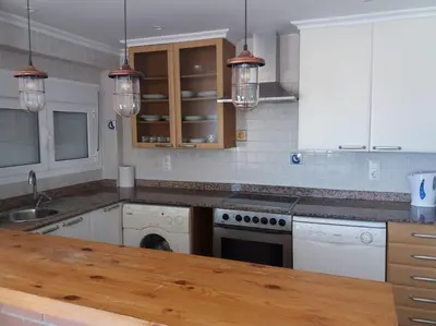 a kitchen with white appliances and a wooden counter top at The perfect holiday apartment with fantastic views in Faro de Cullera