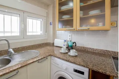 a kitchen with a sink and a washing machine at The perfect holiday apartment with fantastic views in Faro de Cullera