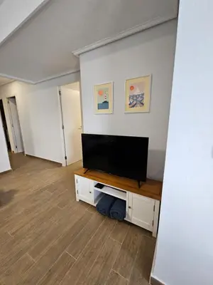 a living room with a flat screen tv on a wall at The perfect holiday apartment with fantastic views in Faro de Cullera