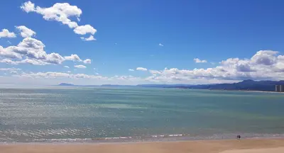 a beach with a person standing on the beach at Primera linea - Descanso Sol y Mar in Cullera