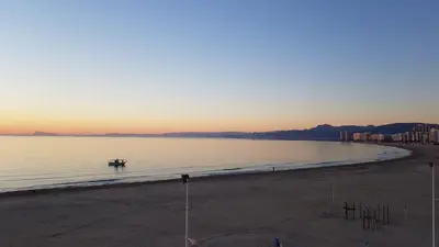 a view of a beach with a boat in the water at Primera linea - Descanso Sol y Mar in Cullera