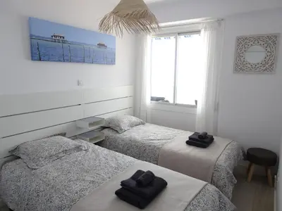 a bedroom with two beds with towels on them at Primera linea - Descanso Sol y Mar in Cullera