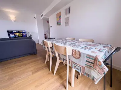 a dining room table with chairs and a couch at Tranquilidad a 2 minutos del mar in Canet de Berenguer