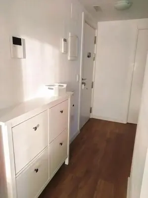 a white bathroom with a sink and a cabinet at Tranquilidad a 2 minutos del mar in Canet de Berenguer