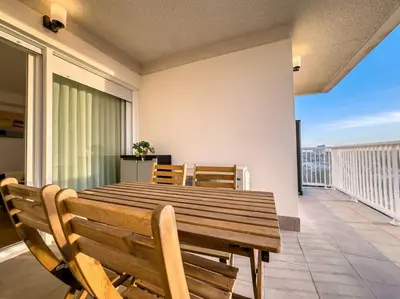 a wooden table and chairs on a balcony at Tranquilidad a 2 minutos del mar in Canet de Berenguer