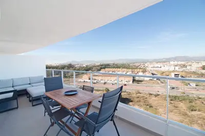 a dining room with a table and chairs on a balcony at Global Vacacional, Apartamento con terraza y vistas al mar y a la montaña in Canet de Berenguer