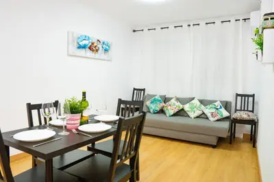 a dining room with a table and a couch at Sollana Arena in Valencia