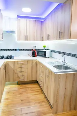 a kitchen with wooden cabinets and a sink at Sollana Arena in Valencia