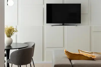 a living room with a couch and a table with a tv at Blanq Marina Suites in Valencia