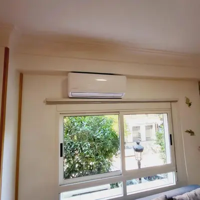 a window with a air conditioner on top of it at Pintor 31 in Valencia