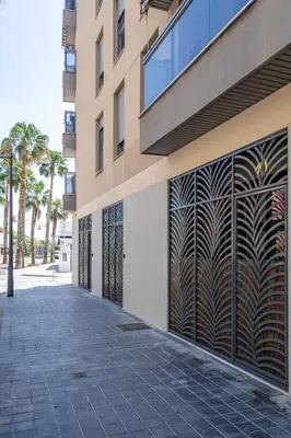 a building with a gate on the side of it at Exquisite studio apartment with an original design in Valencia