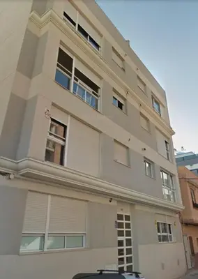 a large white building with many windows on it at UIM Mediterraneo Felipe 6 Wifi in Puerto de Sagunto