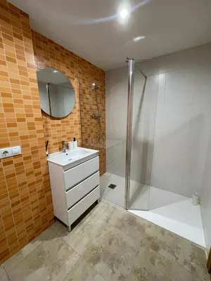 a bathroom with a shower and a sink and a mirror at UIM Mediterraneo Felipe 6 Wifi in Puerto de Sagunto