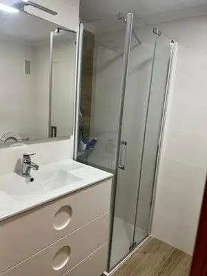 a bathroom with a sink and a glass shower at Casa Schila in Tavernes de Valldigna