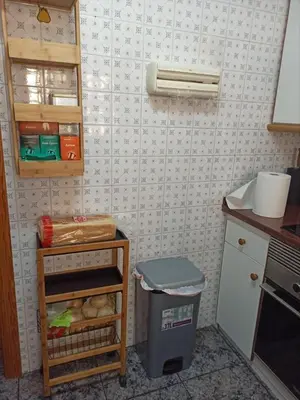a kitchen with a counter and a trash can in it at Casa Schila in Tavernes de Valldigna