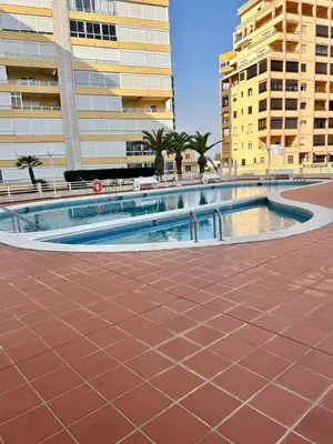 a swimming pool in the middle of a city with buildings at Casa Schila in Tavernes de Valldigna