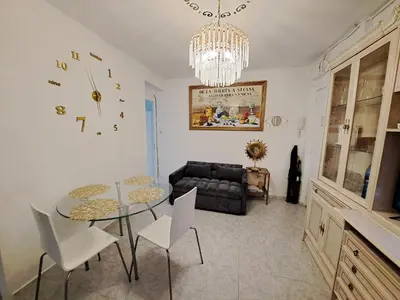 a living room with a table and chairs and a chandelier at Apartamento acogedor con wifi in Valencia
