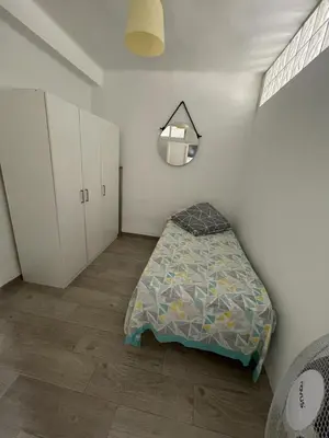 a bedroom with a bed and a mirror on the wall at MALVARROSA BEACH FAMILIAR in Valencia