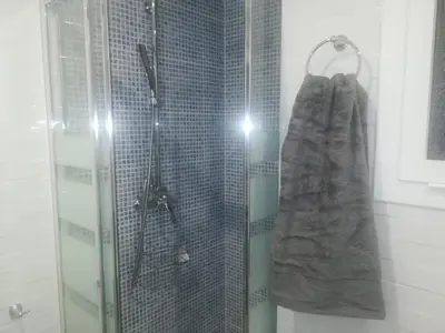 a shower with a glass door and a towel at MALVARROSA BEACH FAMILIAR in Valencia