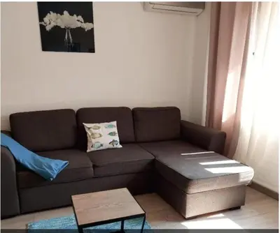 a living room with a brown couch and a coffee table at MALVARROSA BEACH FAMILIAR in Valencia
