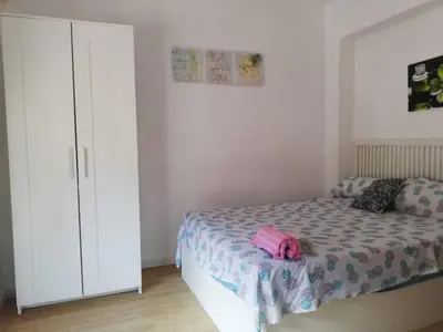 a bedroom with a bed and a white cabinet at Arts and Sciens Museum/Beach in Valencia