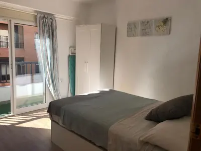 a bedroom with a bed and a large window at Arts and Sciens Museum/Beach in Valencia