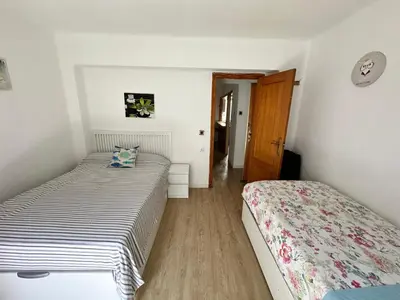 a bedroom with two beds and a hallway at Arts and Sciens Museum/Beach in Valencia