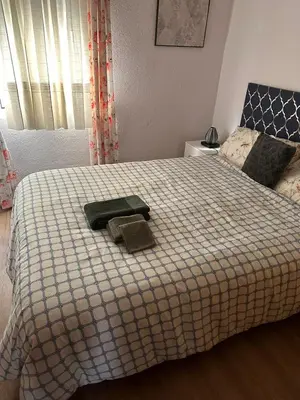 a bedroom with a bed with two towels on it at Apartamento Tavernes Playa in Tavernes de Valldigna