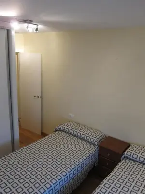a bedroom with two beds and a door to a room at Apartamentos Valencia in Valencia
