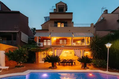 a house with a swimming pool in front of a building at chalet, villa rodeada de naturaleza piscina a doce klm de Valencia y 7 del aeropuerto in Valencia