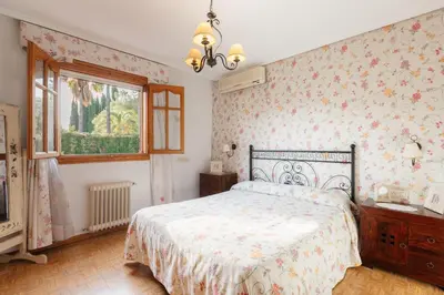 a bedroom with a bed and a window at chalet, villa rodeada de naturaleza piscina a doce klm de Valencia y 7 del aeropuerto in Valencia