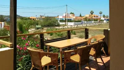 a table and chairs on a balcony with a view at Casa Catinca Cullera - Beach House On the Dune in Cullera