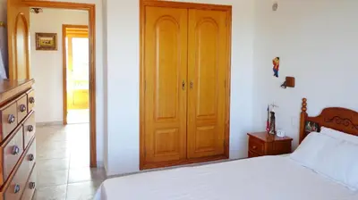 a bedroom with a bed and a wooden door at Casa Catinca Cullera - Beach House On the Dune in Cullera