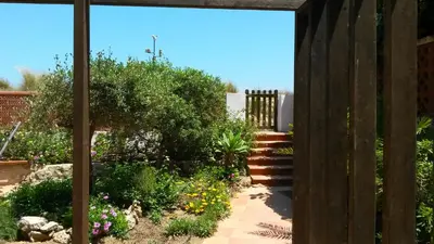 a garden with a wooden fence and a walkway at Casa Catinca Cullera - Beach House On the Dune in Cullera